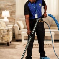 1-800 Water Damage tech cleaning carpet